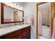 Bathroom features a double sink vanity, decorative mirror, and tiled shower/tub combo with decorative accent at 13313 Cherry Cir, Thornton, CO 80241