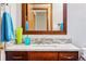 Bathroom features modern vanity, decorative mirror, and tiled backsplash at 13313 Cherry Cir, Thornton, CO 80241