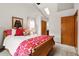 Bedroom featuring soft lighting, a wood-framed bed, and an exterior view at 13313 Cherry Cir, Thornton, CO 80241