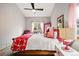 Bedroom features bright lighting, a comfortable chair, and a stylish window at 13313 Cherry Cir, Thornton, CO 80241