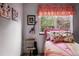 Bright bedroom with colorful accents, a window view, and unique wall decor at 13313 Cherry Cir, Thornton, CO 80241