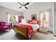 Cozy bedroom with a sloped ceiling, ample natural light, and playful decor at 13313 Cherry Cir, Thornton, CO 80241