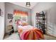 Cozy bedroom with colorful bedding, gray walls, and a decorative window valance at 13313 Cherry Cir, Thornton, CO 80241