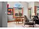 Dining area with a wooden table, benches, a large arched window, and colorful wall art at 13313 Cherry Cir, Thornton, CO 80241