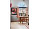 Dining area with a wooden table, benches, a large arched window, and colorful wall art at 13313 Cherry Cir, Thornton, CO 80241