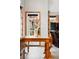 Dining area with a wooden table, benches, a large arched window, and colorful wall art at 13313 Cherry Cir, Thornton, CO 80241
