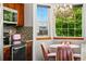 Bright eat-in kitchen area with a bay window, chandelier, and cozy dining set with views to the outside at 13313 Cherry Cir, Thornton, CO 80241