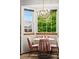 Bright eat-in kitchen area with a bay window, chandelier, and cozy dining set with views to the outside at 13313 Cherry Cir, Thornton, CO 80241
