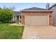 Well-maintained home exterior with a two-car garage, landscaped yard, and inviting curb appeal at 13313 Cherry Cir, Thornton, CO 80241