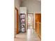 Hallway with wood floors, shelving, and doors leading to various rooms at 13313 Cherry Cir, Thornton, CO 80241