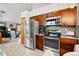 Well-lit kitchen with stainless steel appliances and light wood floors at 13313 Cherry Cir, Thornton, CO 80241