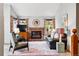 Inviting living room with a brick fireplace, large windows, and comfortable seating arrangement at 13313 Cherry Cir, Thornton, CO 80241