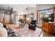 Bright living room with wood floors, large window, and stylish furnishings under a vaulted ceiling at 13313 Cherry Cir, Thornton, CO 80241