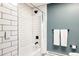 Modern bathroom with white subway tile shower and contrasting black fixtures at 7290 Timber Trail Rd, Evergreen, CO 80439