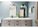 Updated bathroom featuring double sinks with vanity and modern mirrors at 7290 Timber Trail Rd, Evergreen, CO 80439