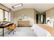 Bright bedroom with skylight features dedicated desk area and dresser storage, plus a view to the hallway at 7290 Timber Trail Rd, Evergreen, CO 80439