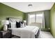 Bedroom with dark wood accents has a large window view, a white bed, and a modern table lamp at 7290 Timber Trail Rd, Evergreen, CO 80439