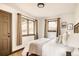 Calm bedroom with two windows, neutral tones, and carpeted floor at 7290 Timber Trail Rd, Evergreen, CO 80439