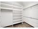 Spacious walk-in closet with custom shelving and hanging rods, providing ample storage at 7290 Timber Trail Rd, Evergreen, CO 80439