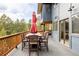 Relaxing deck with outdoor seating and picturesque views of surrounding nature and trees at 7290 Timber Trail Rd, Evergreen, CO 80439