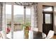 Dining area with large windows, beautiful views, and access to the deck at 7290 Timber Trail Rd, Evergreen, CO 80439