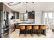 Modern kitchen boasts stainless appliances, island with seating and mountain views at 7290 Timber Trail Rd, Evergreen, CO 80439