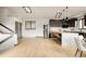 Open concept living area features skylights and modern kitchen with island seating at 7290 Timber Trail Rd, Evergreen, CO 80439