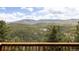 Enjoy breathtaking mountain views from the property's wooden deck with incredible natural landscapes at 7290 Timber Trail Rd, Evergreen, CO 80439