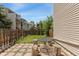 Cozy backyard patio area with green lawn and charming wood fence at 6011 Yarrow St # I, Arvada, CO 80004