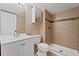 Bathroom featuring a tiled stand-up shower, toilet, and sink with white vanity at 6011 Yarrow St # I, Arvada, CO 80004