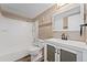 Bathroom featuring a shower-tub combo, toilet, vanity and wood-look flooring at 6011 Yarrow St # I, Arvada, CO 80004
