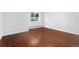 Empty bedroom with light wood flooring, white walls, and a window for natural light at 6011 Yarrow St # I, Arvada, CO 80004