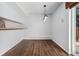 Empty dining room with wood floors, modern pendant light, and a pass-through window to the kitchen at 6011 Yarrow St # I, Arvada, CO 80004