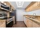 Modern kitchen with stainless appliances, granite counters, and bright lighting for a functional cooking space at 6011 Yarrow St # I, Arvada, CO 80004
