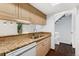 Updated kitchen boasts granite counters, stainless sink, and easy access to the adjacent dining area at 6011 Yarrow St # I, Arvada, CO 80004