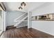 Open floor plan featuring wood flooring and a staircase, pass-through to the kitchen at 6011 Yarrow St # I, Arvada, CO 80004