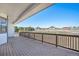 A large back deck offers scenic views of the surrounding open space and a white fence-lined property at 10071 E 142Nd Ave, Brighton, CO 80602