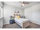 Charming bedroom with carpeted floors, a bright window, and decorative lamps on either side of the bed at 10071 E 142Nd Ave, Brighton, CO 80602