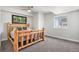 Cozy bedroom with carpeted floors, natural wood bed, and plenty of natural light from the window at 10071 E 142Nd Ave, Brighton, CO 80602