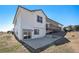 A two story home showcases a walk out basement, back patio, and a deck overlooking an expansive backyard at 10071 E 142Nd Ave, Brighton, CO 80602
