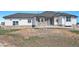 Charming single-story home boasts a stone-accented facade, white siding, and a beautifully landscaped front yard at 10071 E 142Nd Ave, Brighton, CO 80602