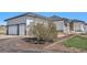 Attached three-car garage with white doors, situated next to the home's stone and siding exterior at 10071 E 142Nd Ave, Brighton, CO 80602