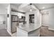 Finished basement kitchenette with modern appliances, bright lighting and stylish island at 10071 E 142Nd Ave, Brighton, CO 80602