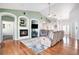 Bright and airy living room with a fireplace, hardwood floors, and an open layout at 10071 E 142Nd Ave, Brighton, CO 80602