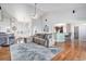 Open concept living area with high ceilings, hardwood floors, a fireplace, and seamless flow to the kitchen at 10071 E 142Nd Ave, Brighton, CO 80602