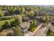 Aerial view of the home on a tree-lined street, showcasing a spacious lot and green surroundings at 794 W Elati Cir, Littleton, CO 80120