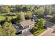 Aerial view of a two-story home with a spacious yard, mature trees, and a two-car garage at 794 W Elati Cir, Littleton, CO 80120