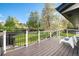 Spacious outdoor deck offering backyard views, with modern lounge chairs and black metal railing at 794 W Elati Cir, Littleton, CO 80120