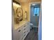 Modern bathroom with double sinks, granite countertops, elegant fixtures, and wood-look flooring for a spa-like experience at 794 W Elati Cir, Littleton, CO 80120