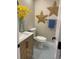 Charming powder room with wood-look vanity, creative star decor, and blue patterned floor tiles for a beachy aesthetic at 794 W Elati Cir, Littleton, CO 80120